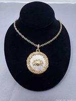 Front view of round Cancer medallion pendant on rope chain