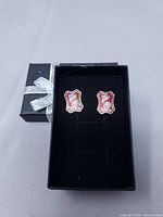 Front view of earrings in box