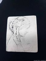 front view of porcelain brooch showing woman's profile and ERNTE inscription