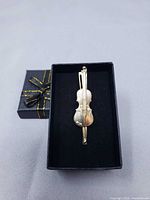 Front view of violin money clip in box