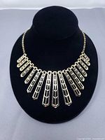 Full necklace displayed on black bust showing overall design