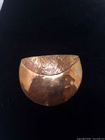 Front view showing hammered copper brooch design