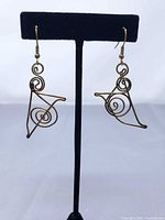 Earrings on stand showing overall design and length