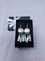 Pair of earrings in open gift box showing overall design
