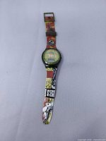 Full watch laid flat showing strap graphics and case