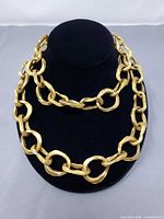 Full view of necklace draped on stand showing size and design