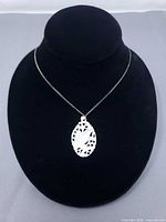 Full necklace displayed on bust showing pendant and chain