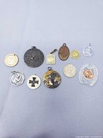 All ten medallions and charms laid out for size and variety reference
