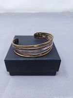 front view of five-band mixed-metal cuff on box