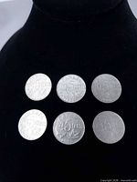 Front view of all six coins showing reverse design and dates