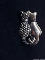 front view of sterling silver twin-cat brooch showing marcasite detail