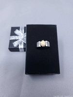 Ring on black box showing full band and stone