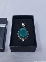 Pendant in gift box showing full design
