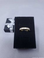 ring displayed on black presentation box