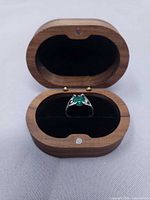 Ring in wooden box, full view