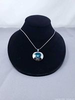 Pendant necklace displayed on bust showing overall design