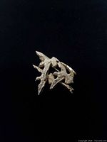 Front view of gold-tone textured three birds brooch