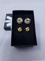 Front view showing both earring pairs in box