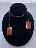 Full view of chain necklace displayed on bust showing two rectangular stone pendants