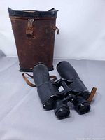 Binoculars and worn leather case, full view