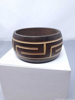 full view of wooden bangle showing carved pattern