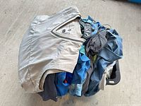 Stack of assorted golf shirts and vest on hanger