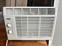 Front view showing grille, control knobs, Arctic King logo