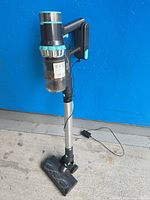 Full view of Belife cordless stick vacuum standing upright with charger connected