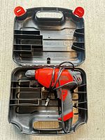 Corded Black & Decker drill inside open molded carry case