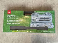 Front image of sealed 14-piece BBQ tool set packaging displaying tool assortment and case