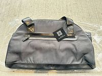 Front view showing Givenchy tag, exterior zip pocket and handles
