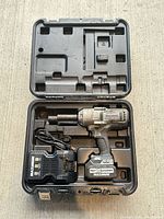 Entire kit in open carry case showing impact wrench, battery, charger