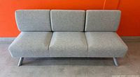 Front view of grey felt three-seat sofa