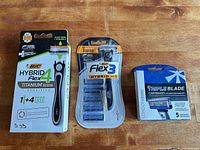 All three sealed shaving packages on table