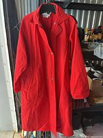 Full view of red cotton long jacket hanging
