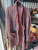 Front view of paisley men’s robe hanging, shows overall design, collar, pockets and hem wear