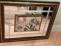 Front view showing entire mirror and central plaque