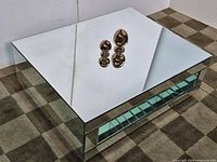 Angled front-right view of mirrored coffee table with reflective surfaces