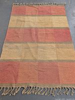 Full view of Persian kilim rug showing entire pattern and fringe