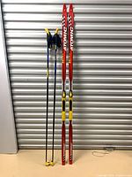 Atomic Beta Racers skis standing with Excel poles