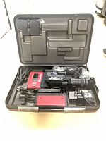 Open hard case showing camcorder, accessories and interior layout