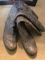 Front angled view of both boots showing distressed leather and shape