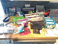 Overview of boxed bulbs, timer, hangers, screws on countertop