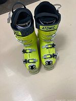 Top view of bright yellow Atomic ski boots showing buckles and branding