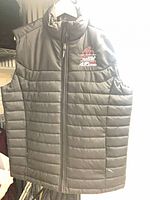 Front view of black quilted StormTech vest, zip front, CN Cycle for CHEO logo