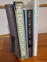 Spines of all four books standing upright