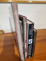 Five upright hardcover books