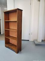 Front view of the solid wood bookshelf showing four tiers