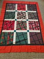 Entire patchwork Christmas tablecloth laid flat on floor