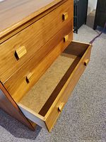 dresser front with bottom drawer open showing interior
